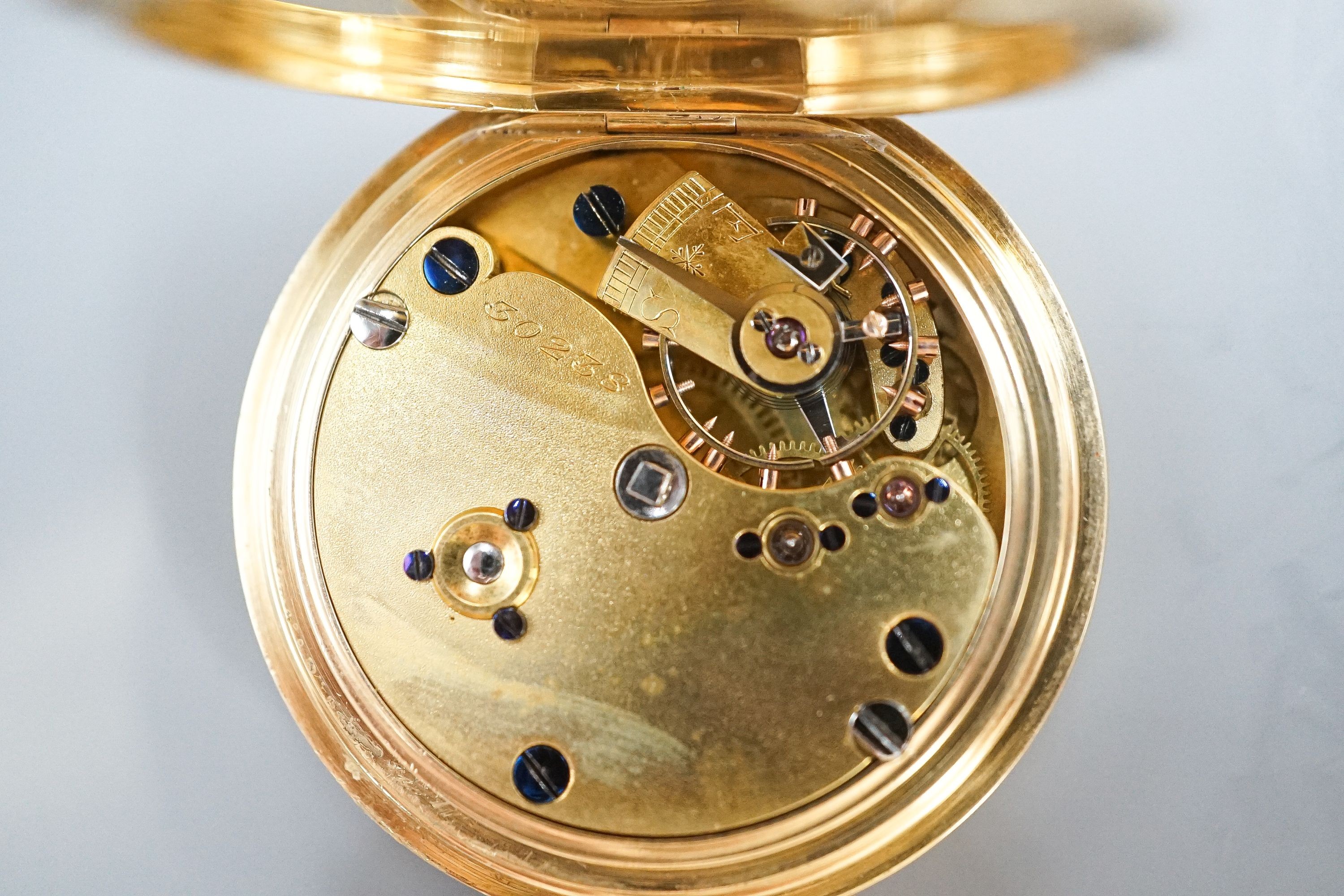 An Edwardian 18ct gold and guilloche enamel half hunter fob pocket watch, case diameter 35mm, gross 47.3 grams.